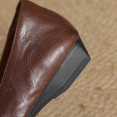 Dark brown genuine leather mule with black rubber sole, side close-up