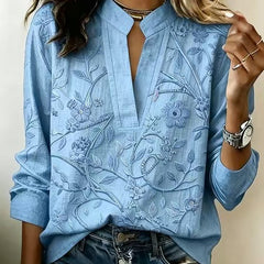 Sky blue embroidered popover blouse with V-neck, front slit, and 3/4 sleeves