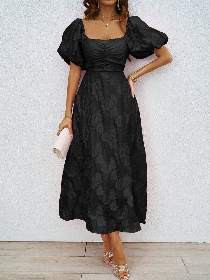 Black off-shoulder midi dress with dramatic puff sleeves and cinched waist