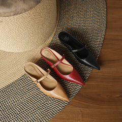Leather mules set with pointed toe straps in maroon, tan, and dark tones