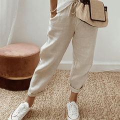 Light beige cotton trousers with elastic waist and cuffed hems