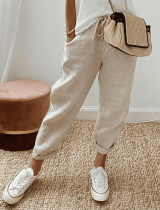 Light beige cotton trousers with elastic waist and cuffed hems
