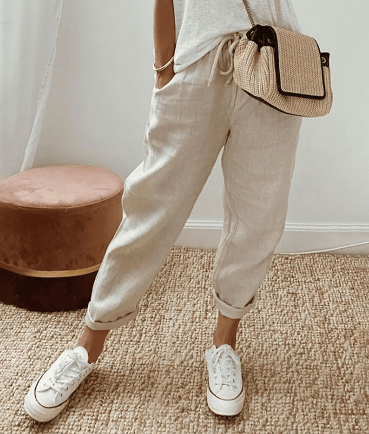 Light beige cotton trousers with elastic waist and cuffed hems