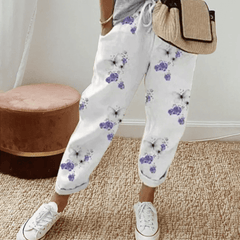 White cotton trousers with purple floral print, elastic waist and cuffed hems