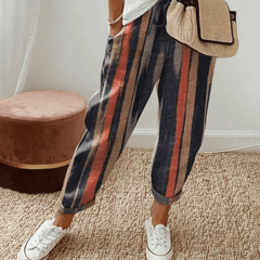 Dark cotton trousers with vertical navy, red, and tan stripes, elastic waist