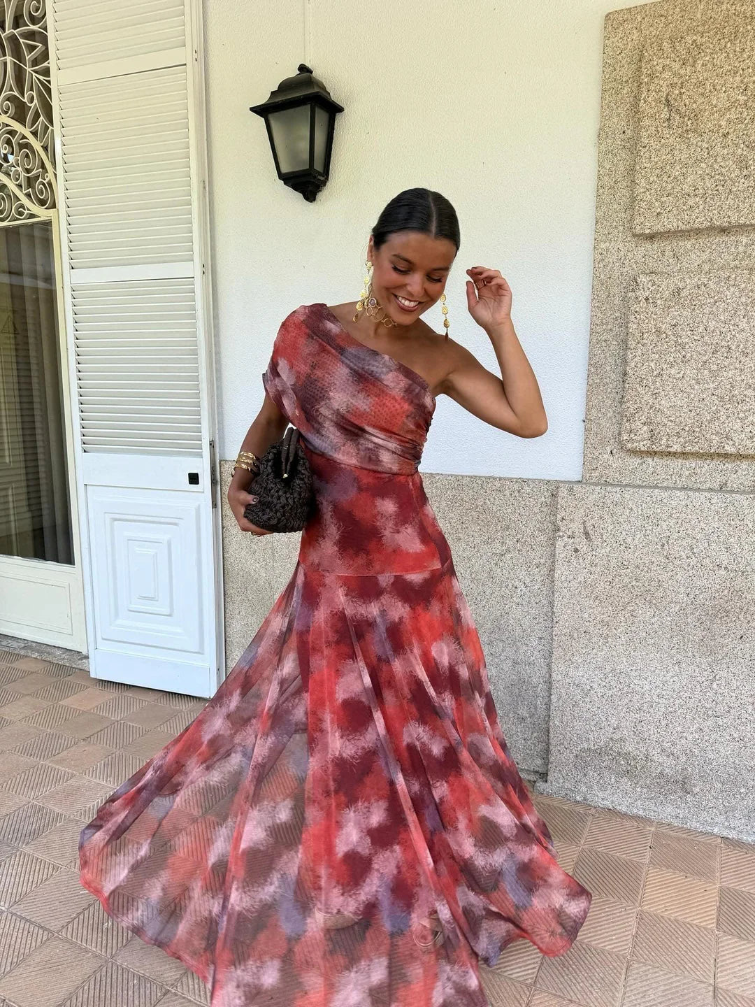 Off-shoulder tie-dye maxi dress in red and purple with flowing pleated skirt