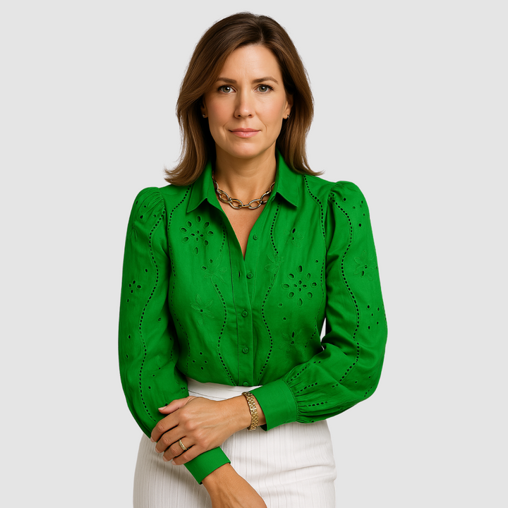 Green button-front blouse with puff sleeves, eyelet embroidery, and tie waist