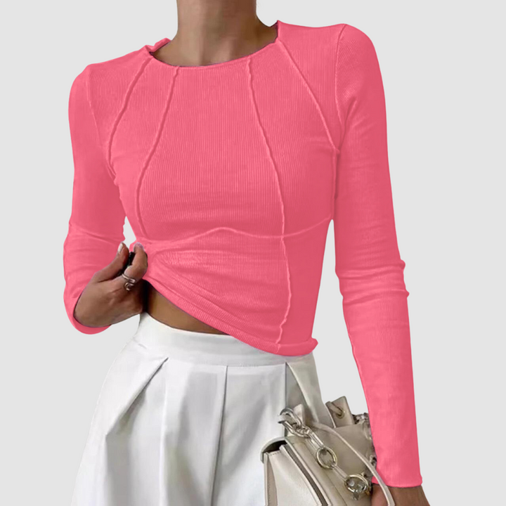 Pink long-sleeve knit top with crew neck and draped ruched front; fitted cropped hem