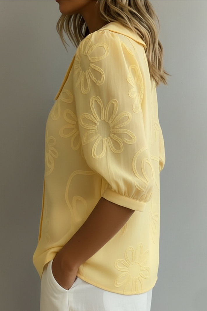 Yellow floral embroidered blouse sleeve with puff detail and subtle flower pattern