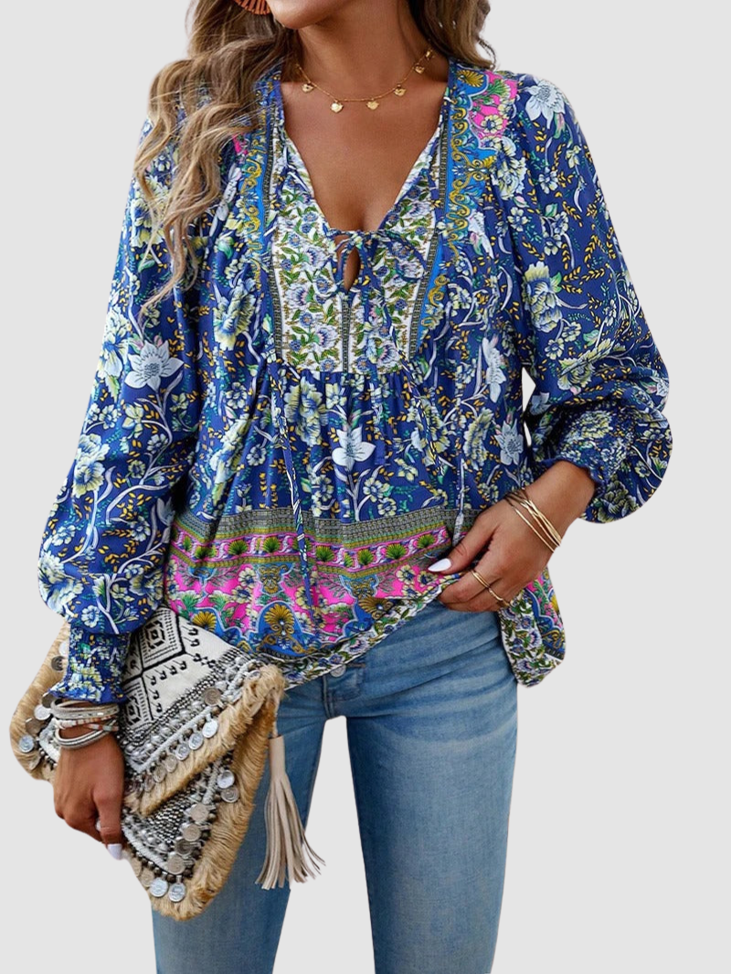 Blue floral peasant blouse with V-neck tie and long puff sleeves, colorful border trim