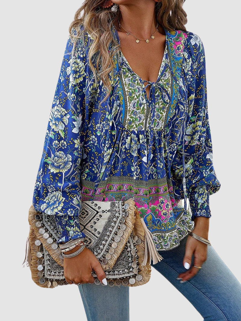 Blue floral blouse with V-neck tie, gathered bodice, and embroidered border trim