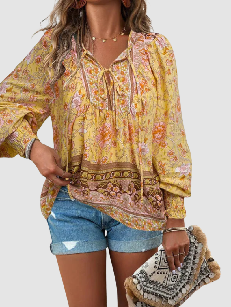 Yellow floral blouse with tie-neck, gathered ruffle yoke, and long puff sleeves