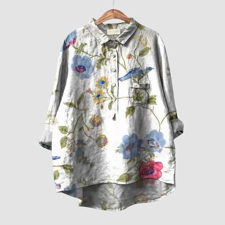 White floral print button-up blouse with pointed collar and chest pocket, blue accents