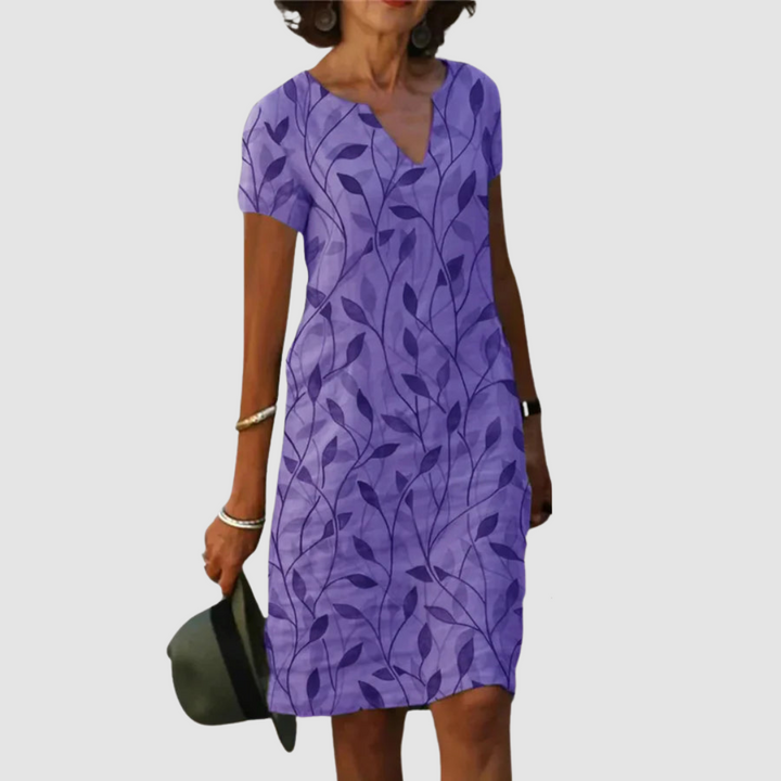Casual printed dress in purple with leaf pattern, short sleeves, V-neck.