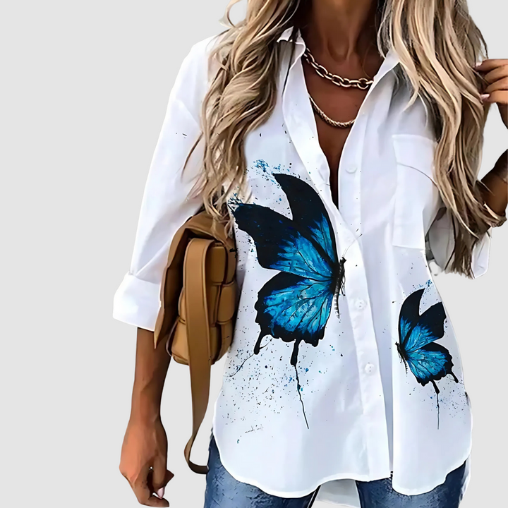 White button-up blouse with bold blue butterfly print front