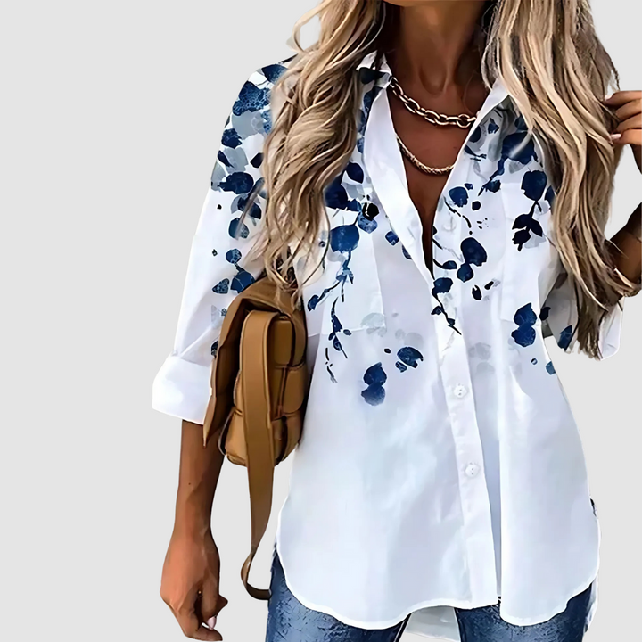 White button-up blouse with blue blossom print on sleeves and front