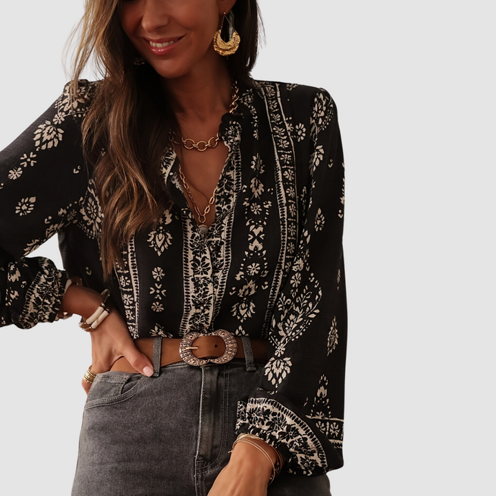 Black boho blouse with white floral print and V-neck, long sleeves and waist belt