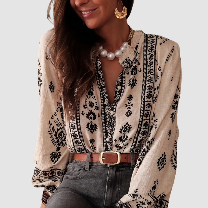 Soft beige boho blouse with black floral border print, V-neck, and long sleeves