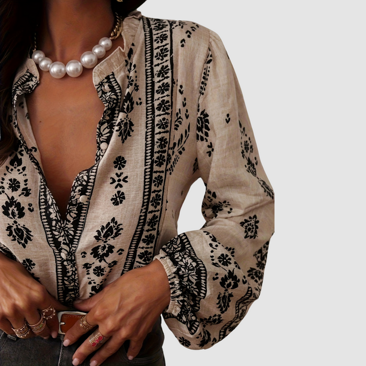 Soft beige boho blouse close-up: black floral and border print, V-neck placket