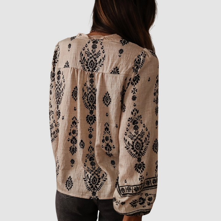 Back view of black boho blouse with white floral print and long balloon sleeves