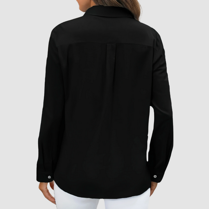 Black pocket blouse, back view with full sleeves and button cuffs