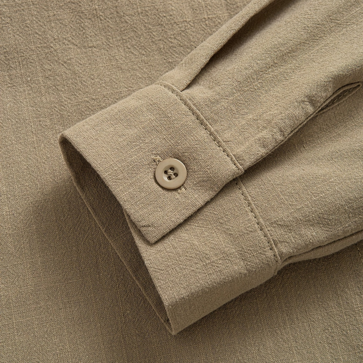 Close-up of sand buttoned cuff on long sleeve blouse