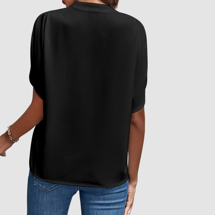 Black draped blouse, back view, loose fit with short dolman sleeves