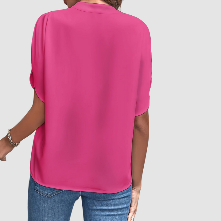 Pink draped blouse, back view, loose fit with short dolman sleeves