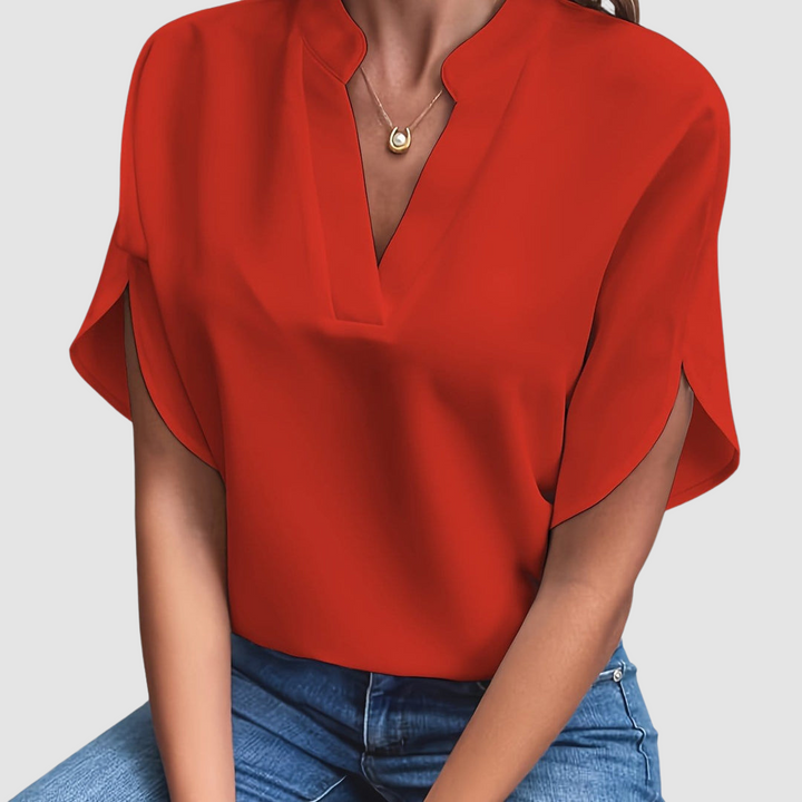 Red draped blouse with V-neck and loose dolman sleeves
