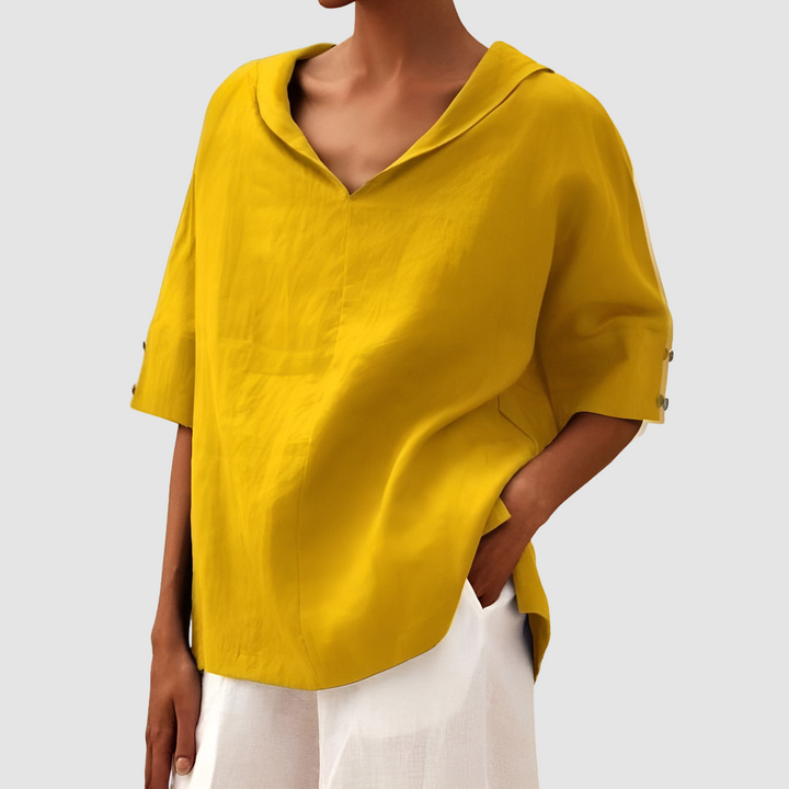 Yellow short-sleeve blouse with V-neck and relaxed, draped cut.