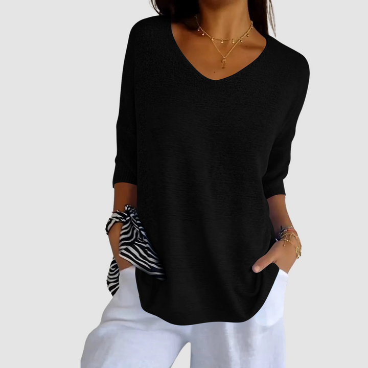 Black knit V-neck top with three-quarter sleeves, relaxed fit and curved hem