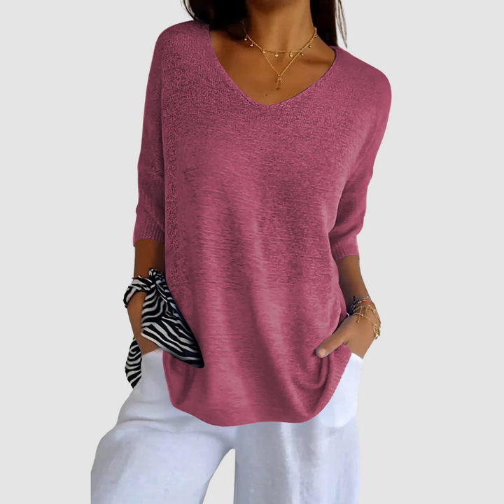 Magenta knit v-neck top with three-quarter sleeves and loose silhouette