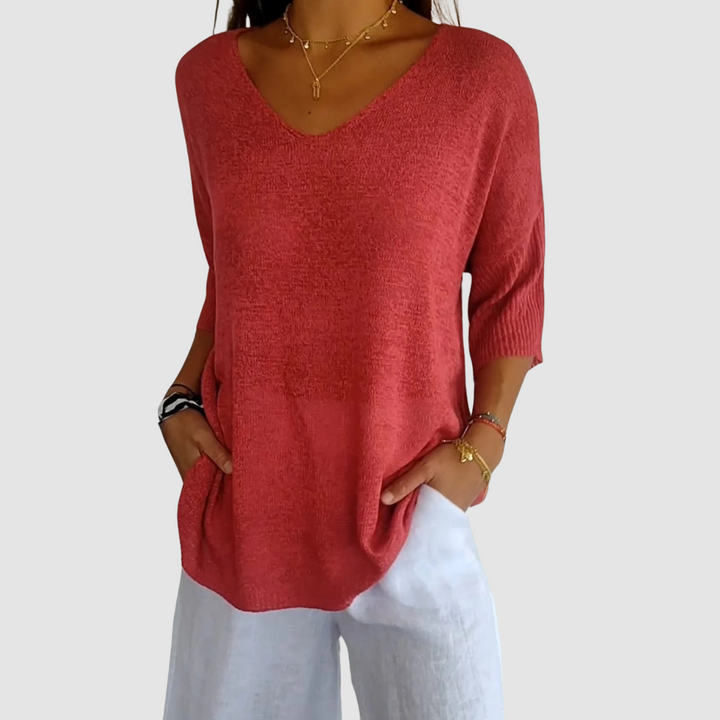 Red knit v-neck top with three-quarter sleeves and soft drape