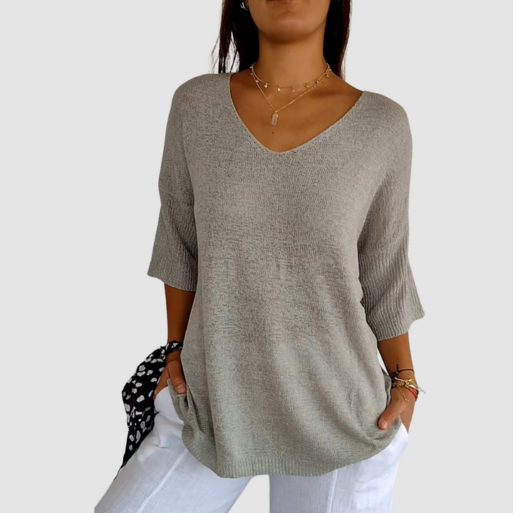 Gray knit V-neck top with 3/4 sleeves and relaxed fit