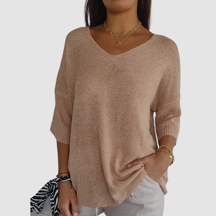 Tan knit V-neck top with three-quarter sleeves and relaxed, airy fit