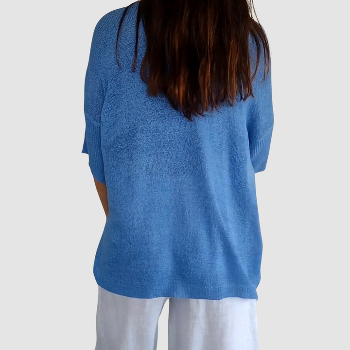 Blue knit v-neck top, back view, relaxed fit and 3/4 sleeves
