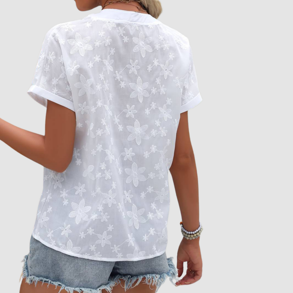 Loose white floral short-sleeve shirt, back view with V-shaped yoke