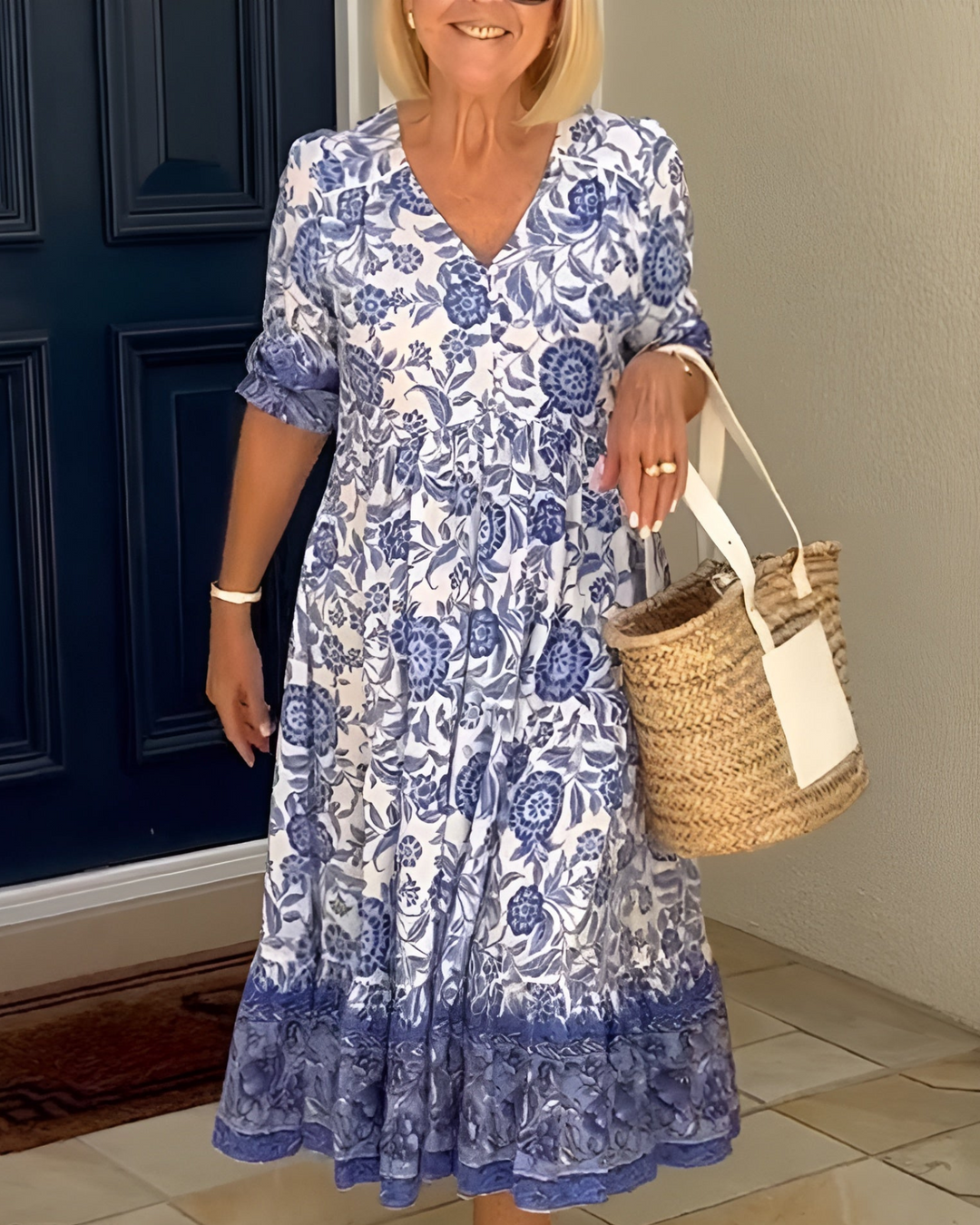 Light blue floral V-neck dress with short sleeves and gathered tiered skirt