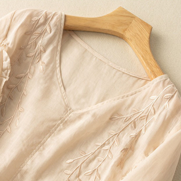 Off-white cotton-linen top neckline with V-stitching and leaf embroidery detail
