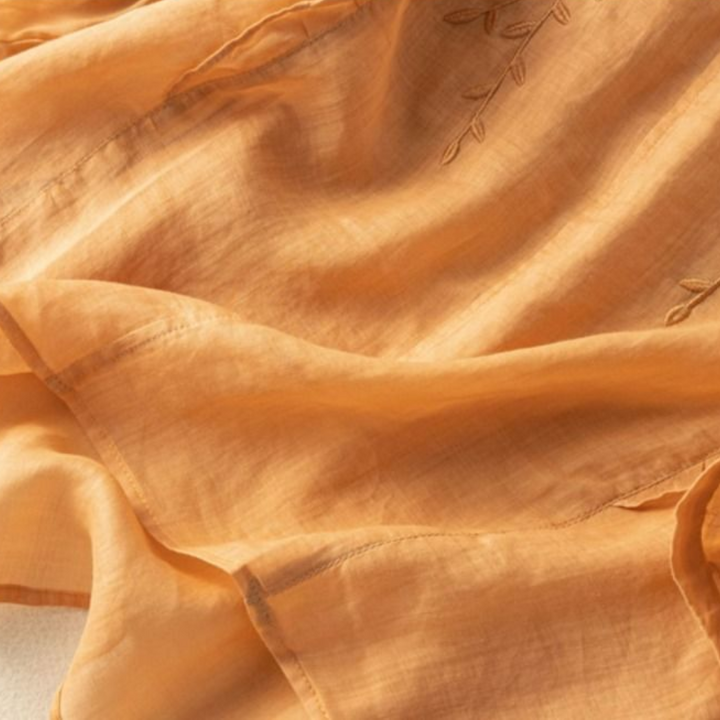 Apricot cotton-linen top fabric with subtle leaf embroidery detail