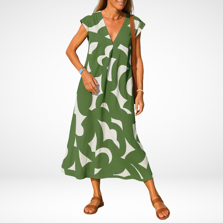 Green flowy V-neck midi dress with abstract white shapes, short cap sleeves.