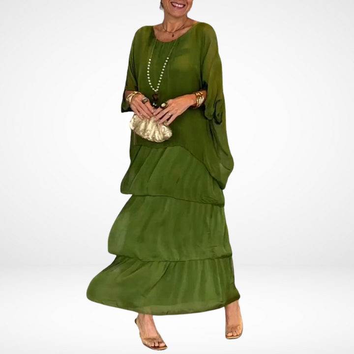 Green loose maxi dress with tiered skirt, drapey dolman sleeves, scoop neckline.