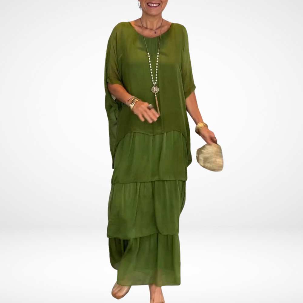 Green tiered maxi dress with drapey dolman sleeves and scoop neckline, loose fit.