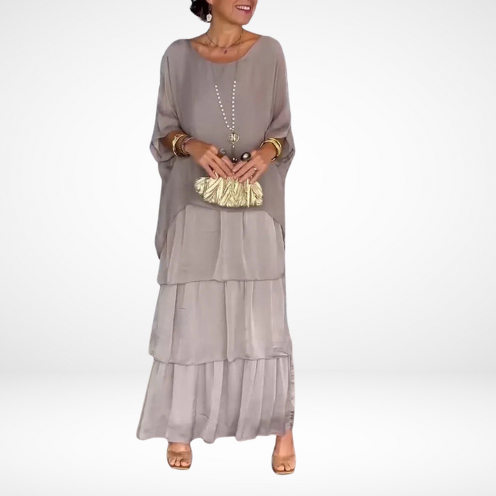 Gray loose maxi dress with tiered skirt, drapey dolman sleeves, scoop neckline.