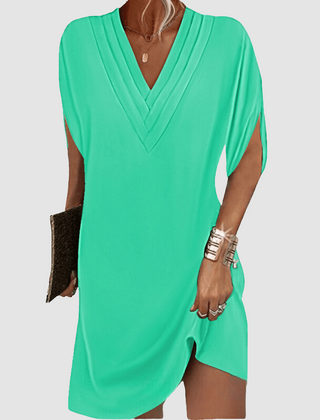 Green V-neck half-sleeve dress with draped wrap-look neckline and short curved hem