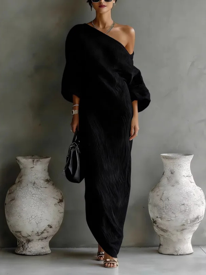 Black one-shoulder maxi dress with draped wrap sash and three-quarter sleeves