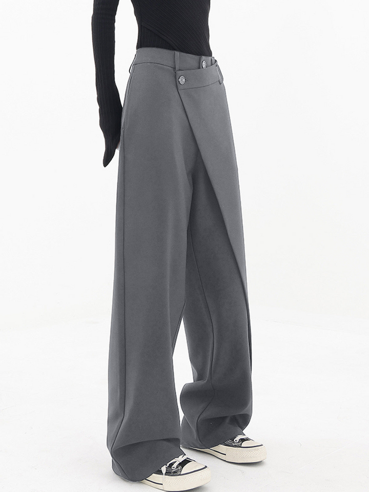 Grey baggy trousers with belt loops, button closure, and wide straight legs