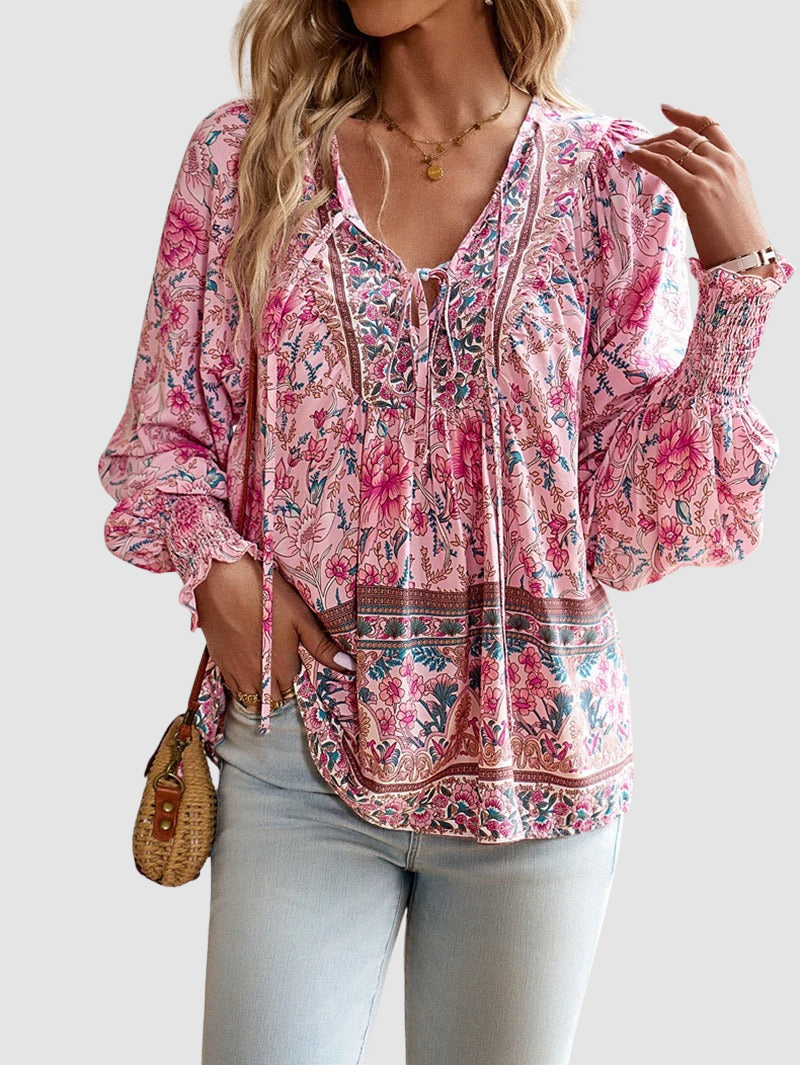 Pink floral peasant blouse with V-neck tie, ruffled yoke, and long puff sleeves