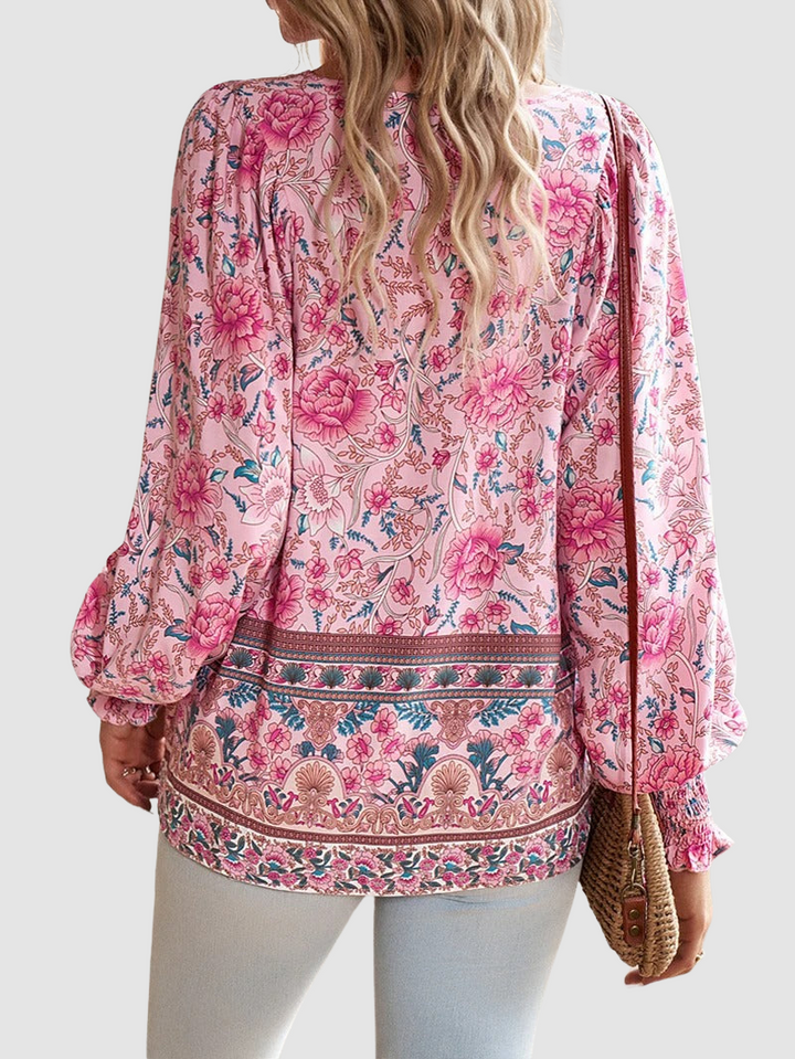 Pink floral peasant blouse with long balloon sleeves and decorative border hem