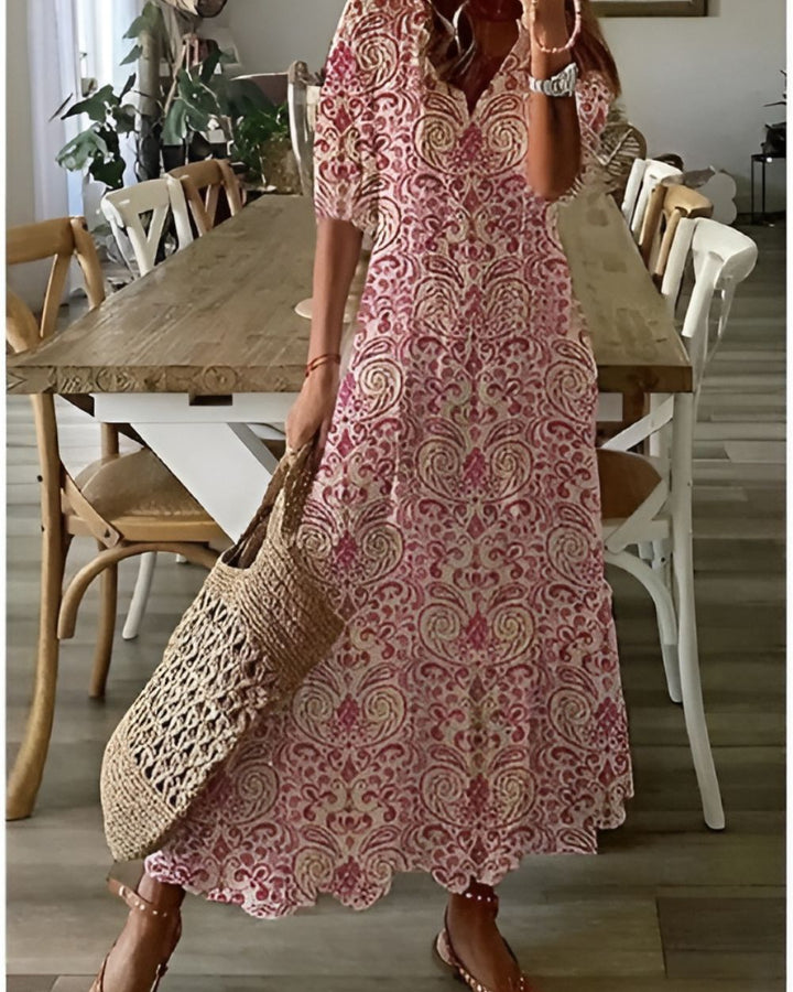 Boho covering dress in red with ornate paisley-style print and short sleeves.